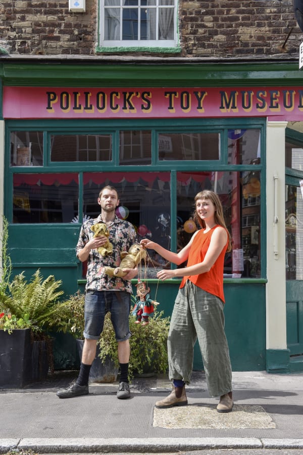 Jack Fawdry Tatham holding antique toys outside of Pollock's Toy Museum in Scala Street Fitzrovia London as part of the Characters of Fitzrovia Project organised by the Rebecca Hossack Art Gallery