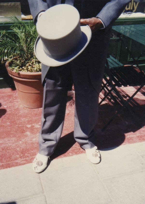 Clifford Possum and his hand painted shoes at the Rebecca Hossack Gallery en route to Buckingham Palace