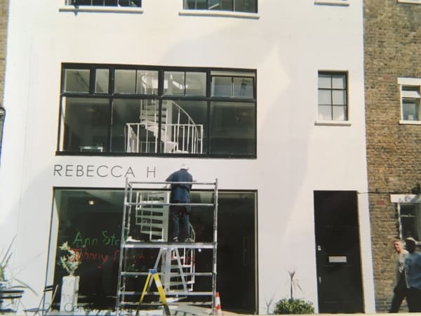 Putting up the gallery sign at the Rebecca Hossack Art Gallery