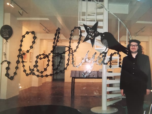 Rob Ryan standing outside his exhibition at the Rebecca Hossack Art Gallery