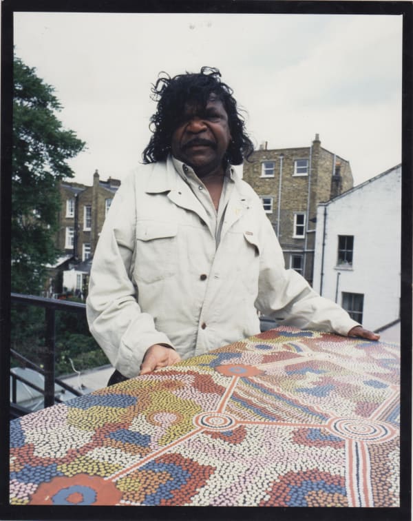 Clifford Possum at the Rebecca Hossack Art Gallery, London with his painting for British Airways' Tail Fin