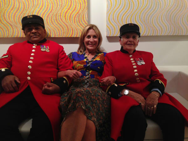 Rebecca Hossack with two Chelsea Pensioners at The Rebecca Hossack Art Gallery