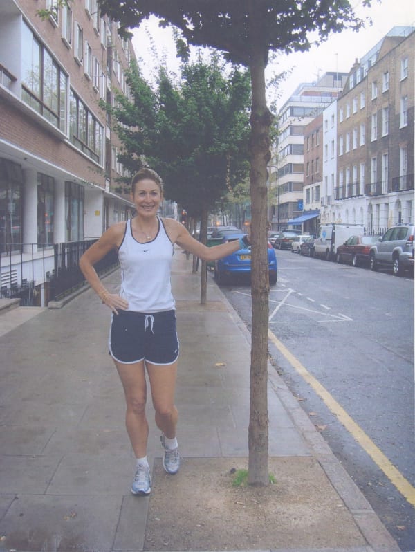 Rebecca Hossack resting next to a tree after running New York marathon