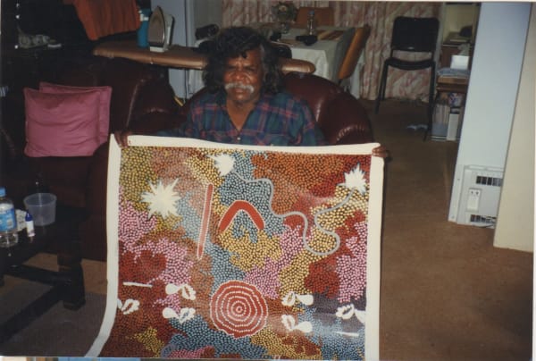 Clifford Possum with one of his artworks