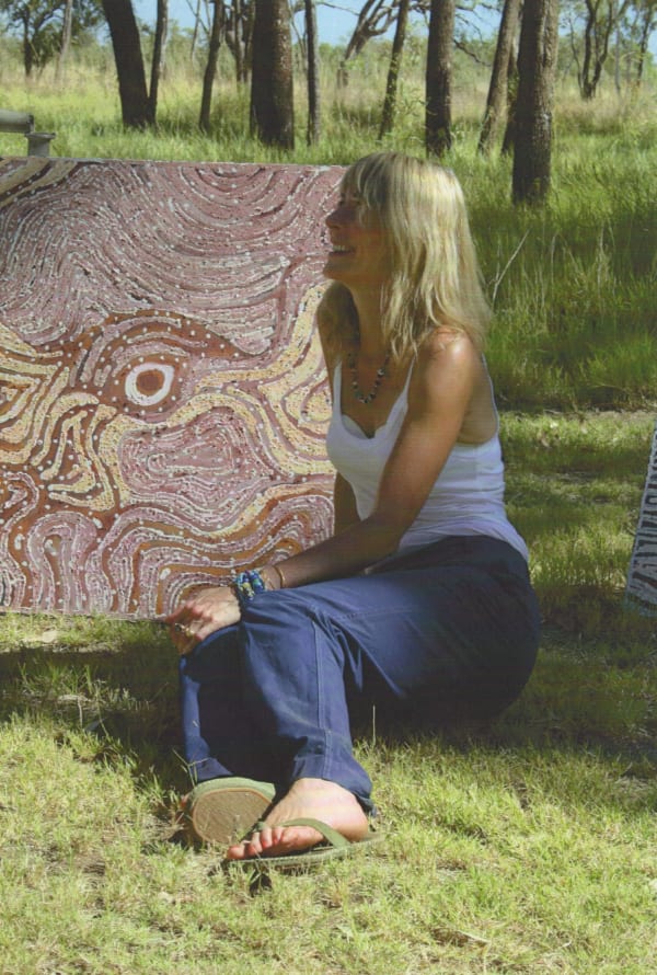 Rebecca Hossack with painting by Lloyd Kwilla in Kununurra, West Australia