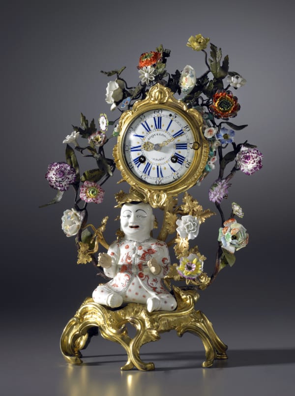 Etienne Roquelon, A Louis XV gilt bronze and porcelain ‘Pendule au Magot’ , by Etienne Roquelon, The magot: China K’ang Hsi period (1662-1722). The gilt bronzes mounts: Paris, date circa 1745. The porcelain flowers: almost certainly Vincennes, date circa 1745