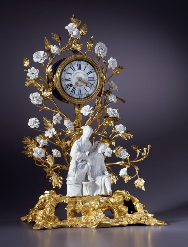 Gudin Le Jeune - A Louis XV mantel clock of eight day duration by Gudin Le Jeune, The gilt bronze: Paris; the figurines: Dehua China; the porcelain flowers: probably Vincennes, date circa 1740-50