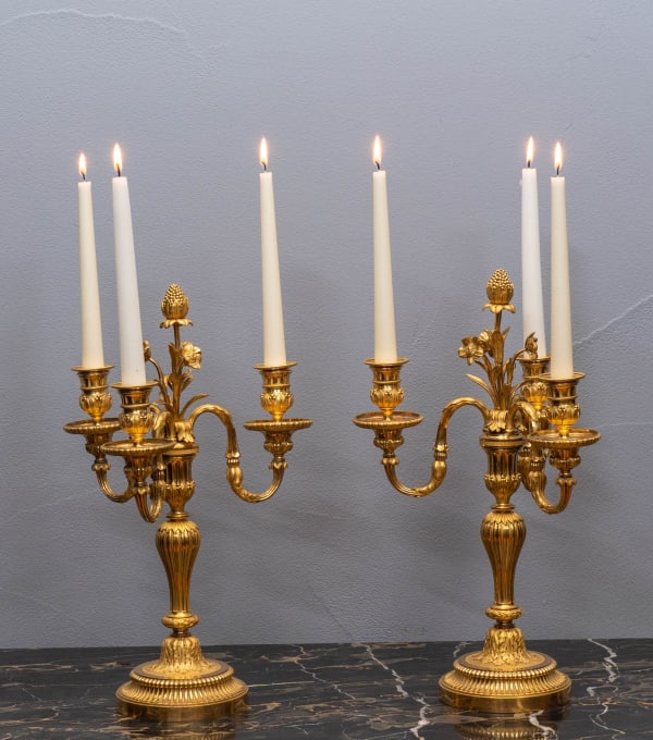 A PAIR OF LOUIS XVI STYLE GILT BRONZE THREE-LIGHT CANDELABRA, Paris, date circa 1820