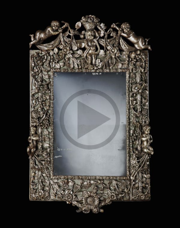 A CHARLES II CARVED AND SILVERED MIRROR