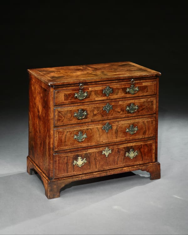 A GEORGE II BURR WALNUT CHEST OF DRAWERS
