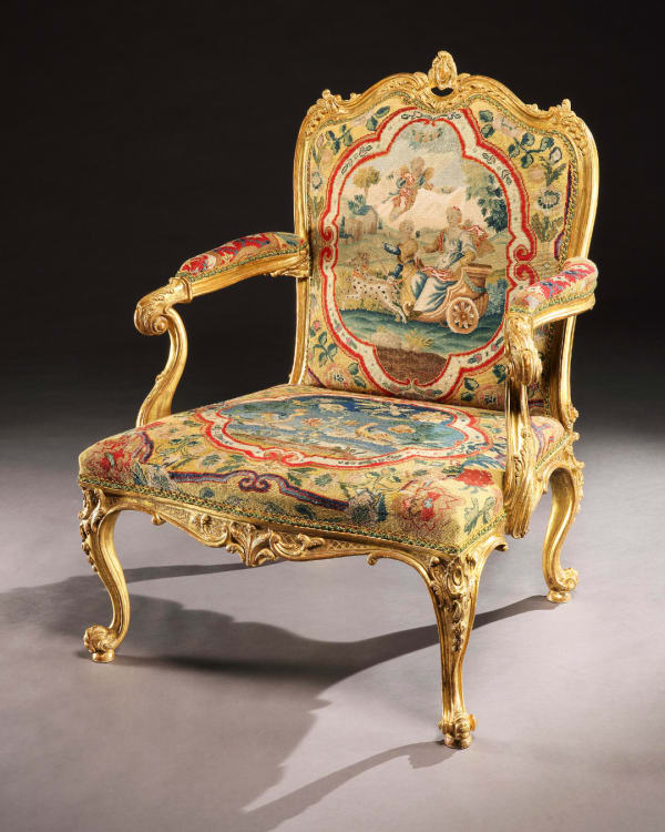 A GEORGE II GILTWOOD ARMCHAIR, The chair: English, circa 1755 The needlework: French, circa 1750