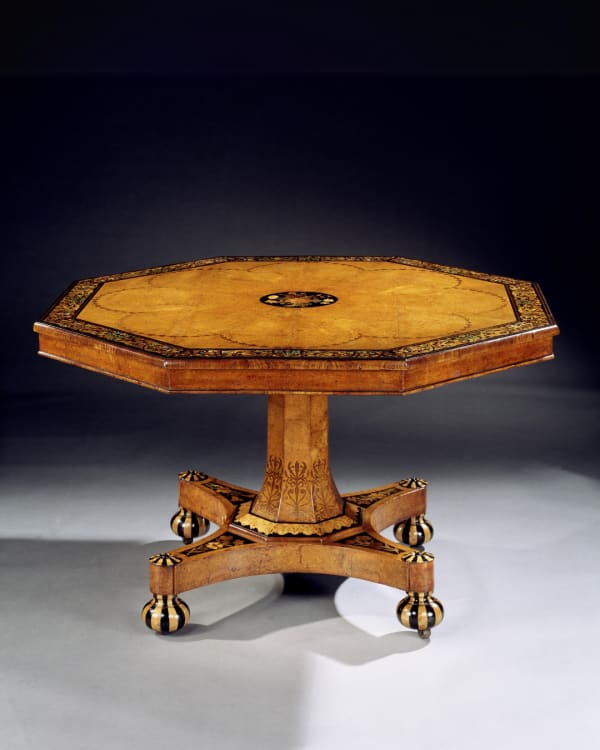 A VICTORIAN INLAID AMBOYNA CENTRE TABLE