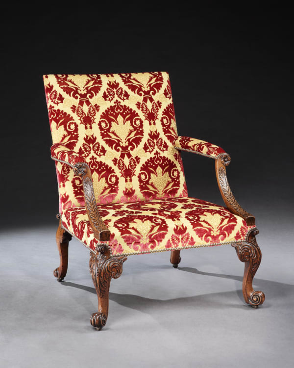 A GEORGE II WALNUT LIBRARY ARMCHAIR ATTRIBUTED TO GILES GRENDEY
