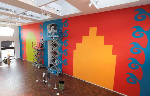 Artist Carlos Rosales-Silva and assistant Cassidy Fritts make final touches on his large mural as part of the San Antonio Museum of Art's Gateway series. Credit: Scott Ball / San Antonio Report