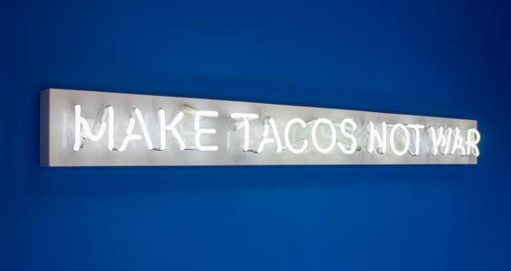 Alejandro Díaz, “Make Tacos Not War,” 1976, neon on clear plexiglass. Photo: Contemporary at Blue Star