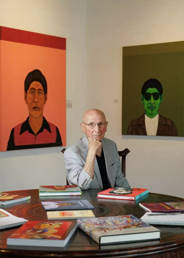 Artist César A. Martínez sits inside Ruiz-Healy Art gallery in front of two of his latest paintings. They are part of the new exhibit "César A. Martínez: Smoke and Mirrors," which is on view through Nov. 30. Sam Owens/San Antonio Express-News