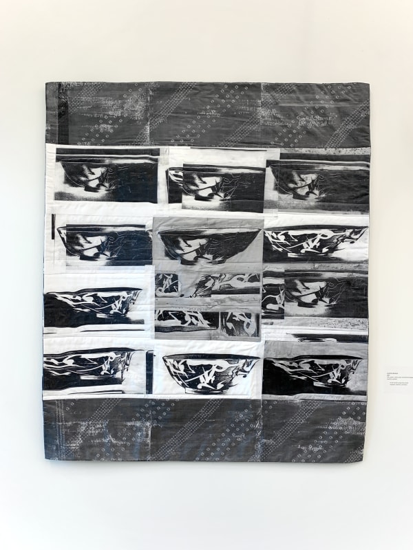 This quilt features the repeating pattern of a Chinese ceramic bowl, transferred from photographs onto silk fabric. The images of the bowls form a grid: four rows of three bowls, with the second bowl of the third row replaced with an abstracted black and