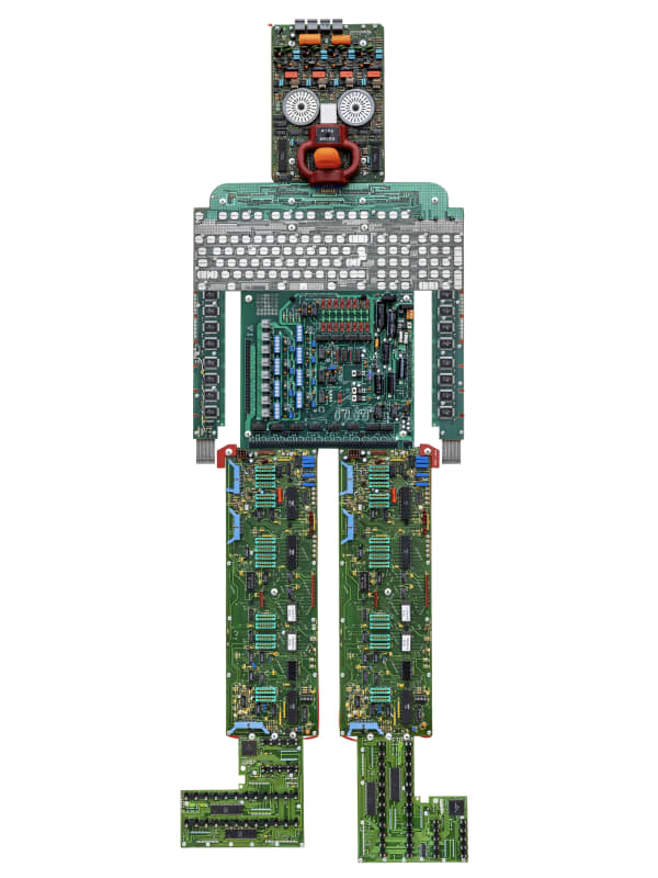 Liz Mamorsky has created a sculptural series of large-scale artwork that have an appearance of robots, or “Artbots”, with varying bold features, colors and sizes. Each of these three wall-hung sculptures is built on a wooden armature covered in reclaimed
