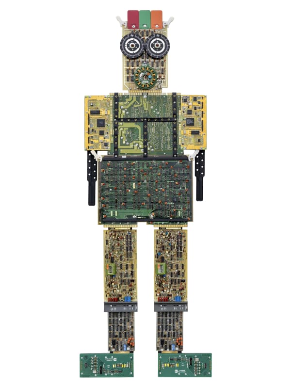 Liz Mamorsky has created a sculptural series of large-scale artwork that have an appearance of robots, or “Artbots”, with varying bold features, colors and sizes. Each of these three wall-hung sculptures is built on a wooden armature covered in reclaimed