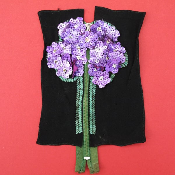 Vintage zipper with a sequin tree design for camouflage.