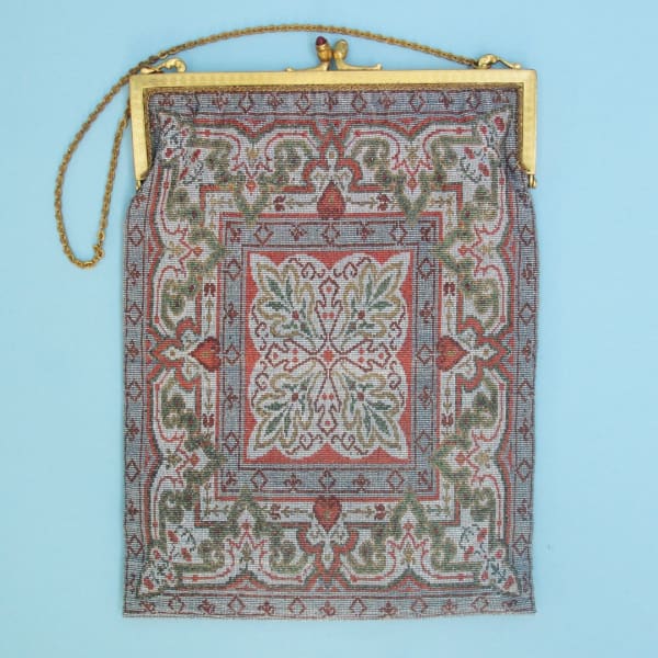 Early 20th century beaded carpet bag with small coin purse. Made in Paris. The lining has worn but otherwise in good condition.
