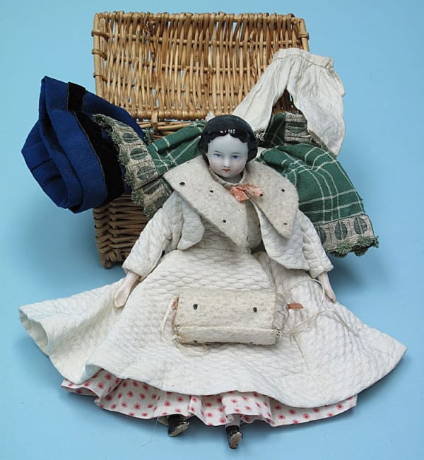 Victorian doll with a selection of clothes.