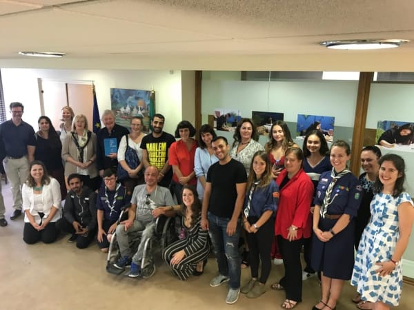 Sculptor John Behan (sixth from left, standing) with refugees, NGO workers and diplomats at the Irish Embassy, Athens this week.
