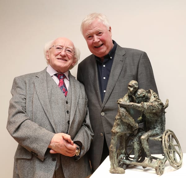 President Michael D. Higgins & artist John Behan RHA stand beside 'The Embrace' sculpture