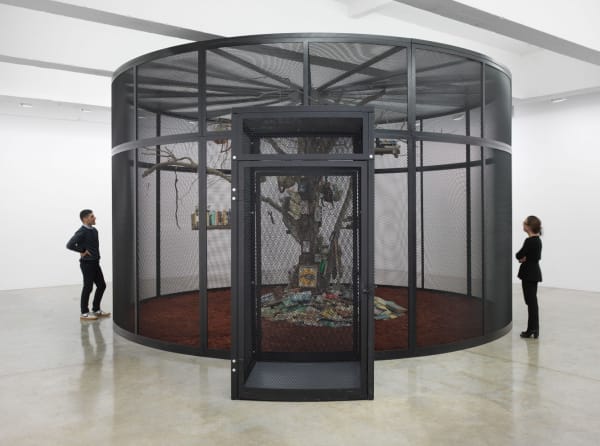 Cage with tree inside and birds and books