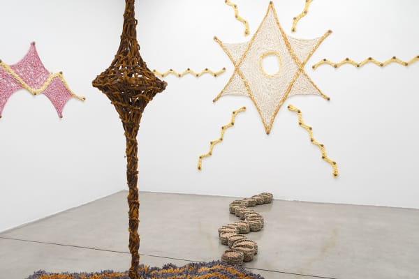 Ernesto Neto installation with crochet in middle of room and crochet on the wall