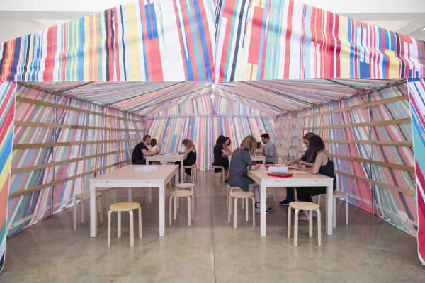 image of a Meschac Gaba tent with tables and drawing material inside