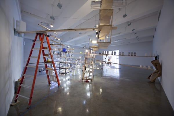 sarah sze installation view of large structure with dimmed lights
