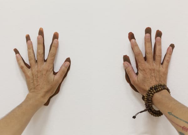 hands touching wall