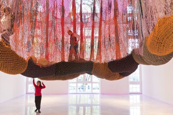 Ernesto Neto crochet hanging installation, walkway for visitors wiht people