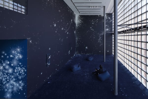 Installation view of blue mural and paintings