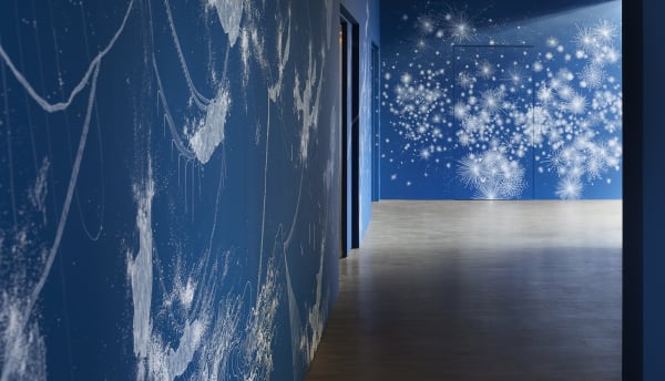 Installation view of blue mural and paintings