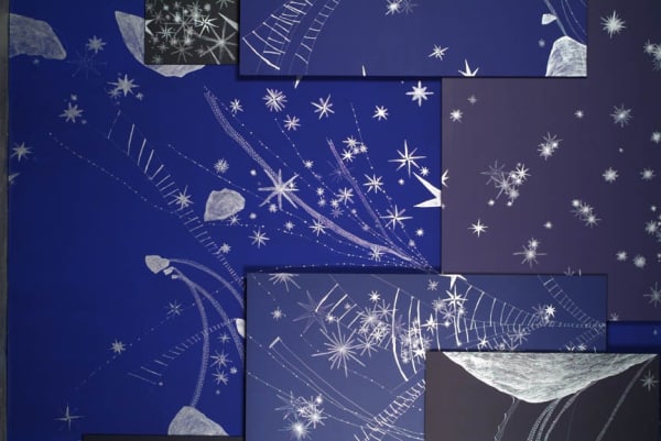image of wall covered in blue paper drawings