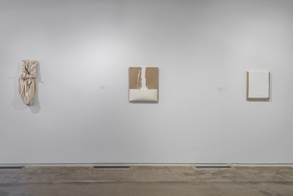 images of installation view paintings hanging on a wall