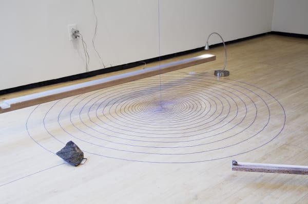 Image of a circles on the floor and rock sculpture