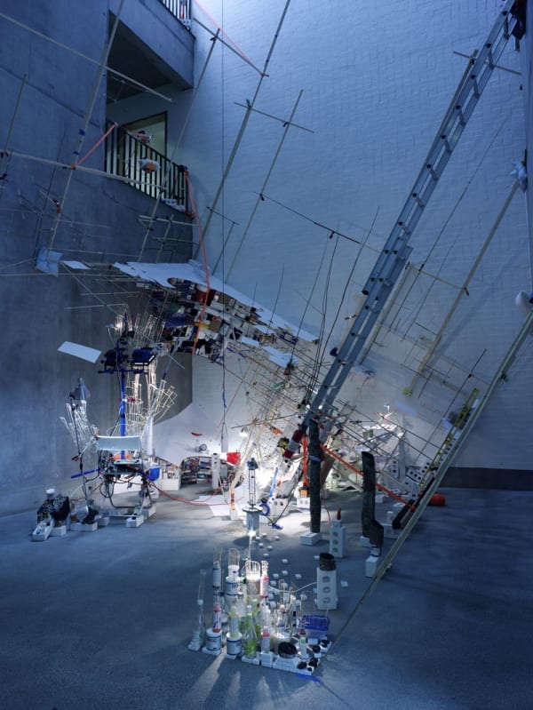 Image of a multi-story installation with ladders and objects