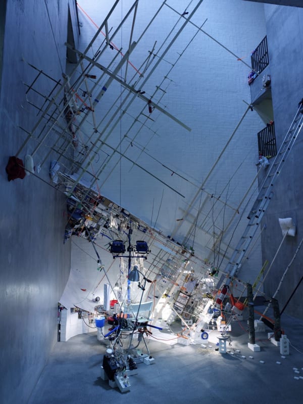 Image of a multi-story installation with ladders and objects