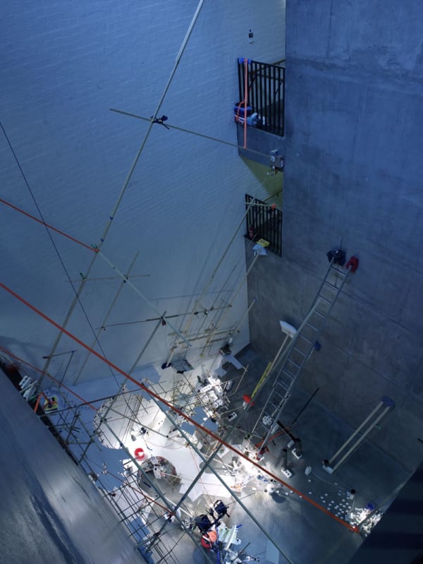 Image of a multi-story installation with ladders and objects