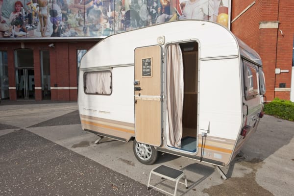 Image of Phil collins installation of trailers outside of museum