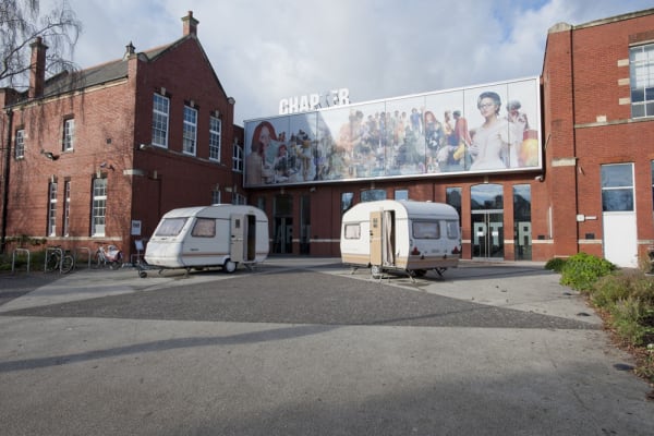Image of Phil collins installation of trailers outside of museum