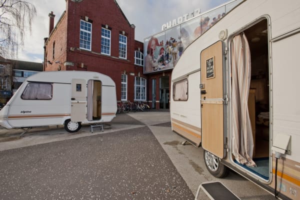 Image of Phil collins installation of trailers outside of museum