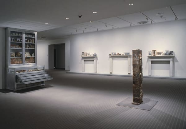 image of installation with cabinet and sculptures at MoMA