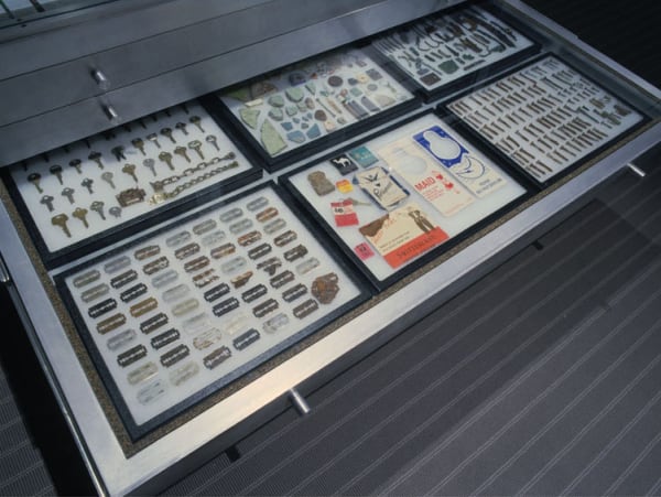 image of installation with cabinet and sculptures at MoMA