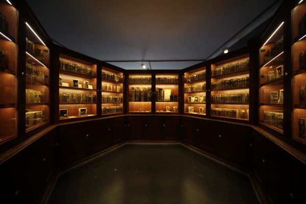 Image of Mark Dion installation, large circular bookcase cabinet