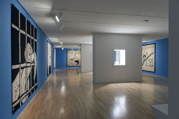 Installation view of Slavs and Tatars at DMA, carpets hanging on blue walls
