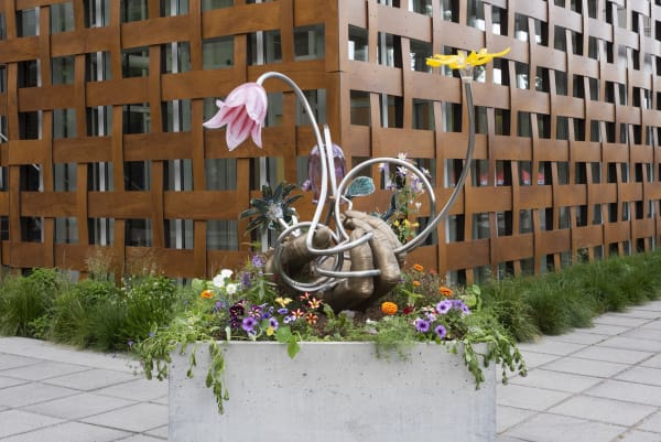 Image of Kelly Akashi bronze hand sculpture with glass flowers